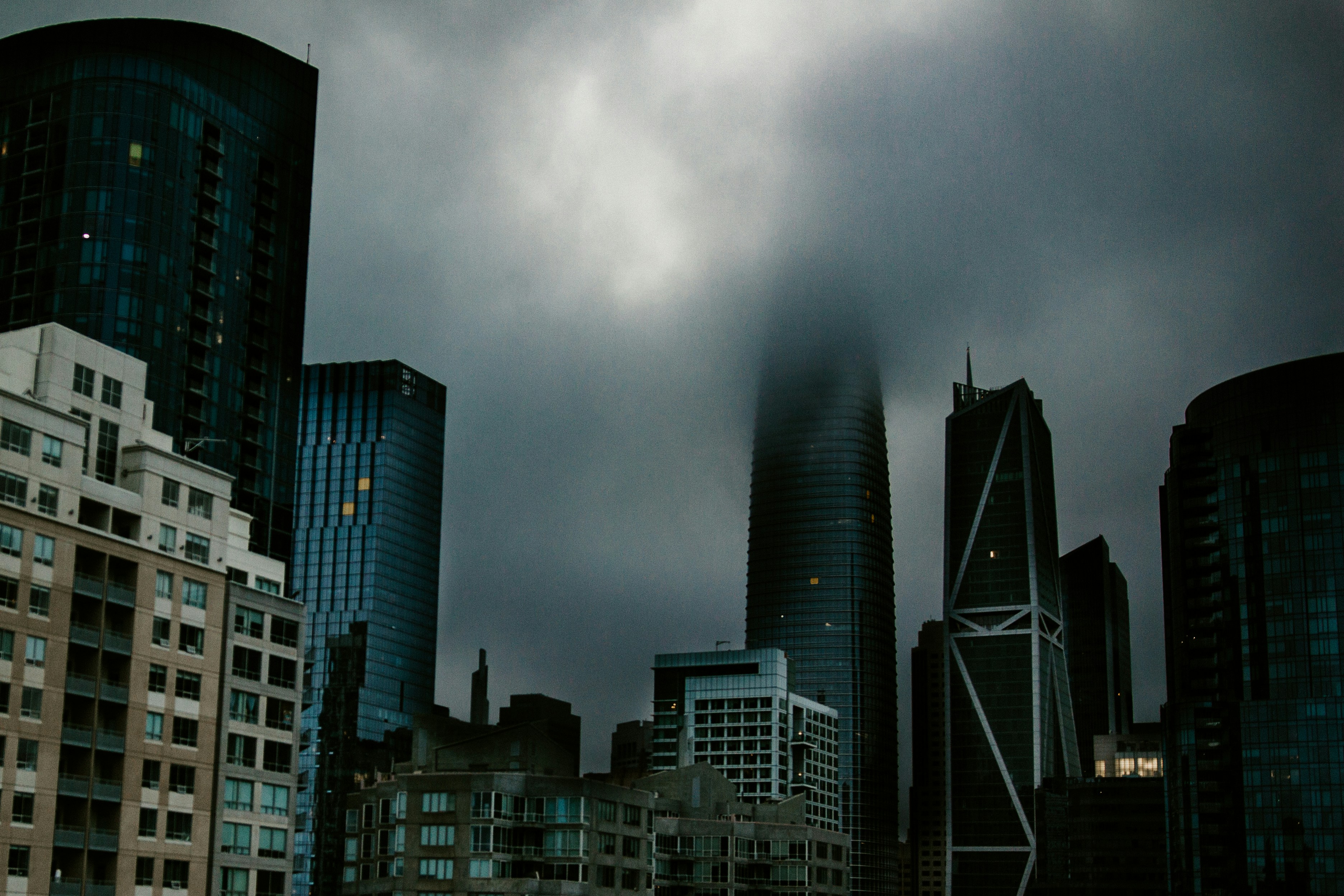 high rise buildings under gray clouds