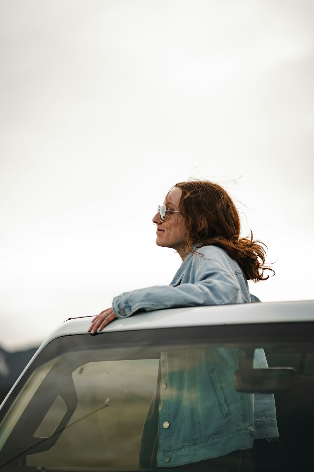 woman in blue long sleeve shirt wearing sunglasses