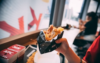 person holding black and white plastic pack