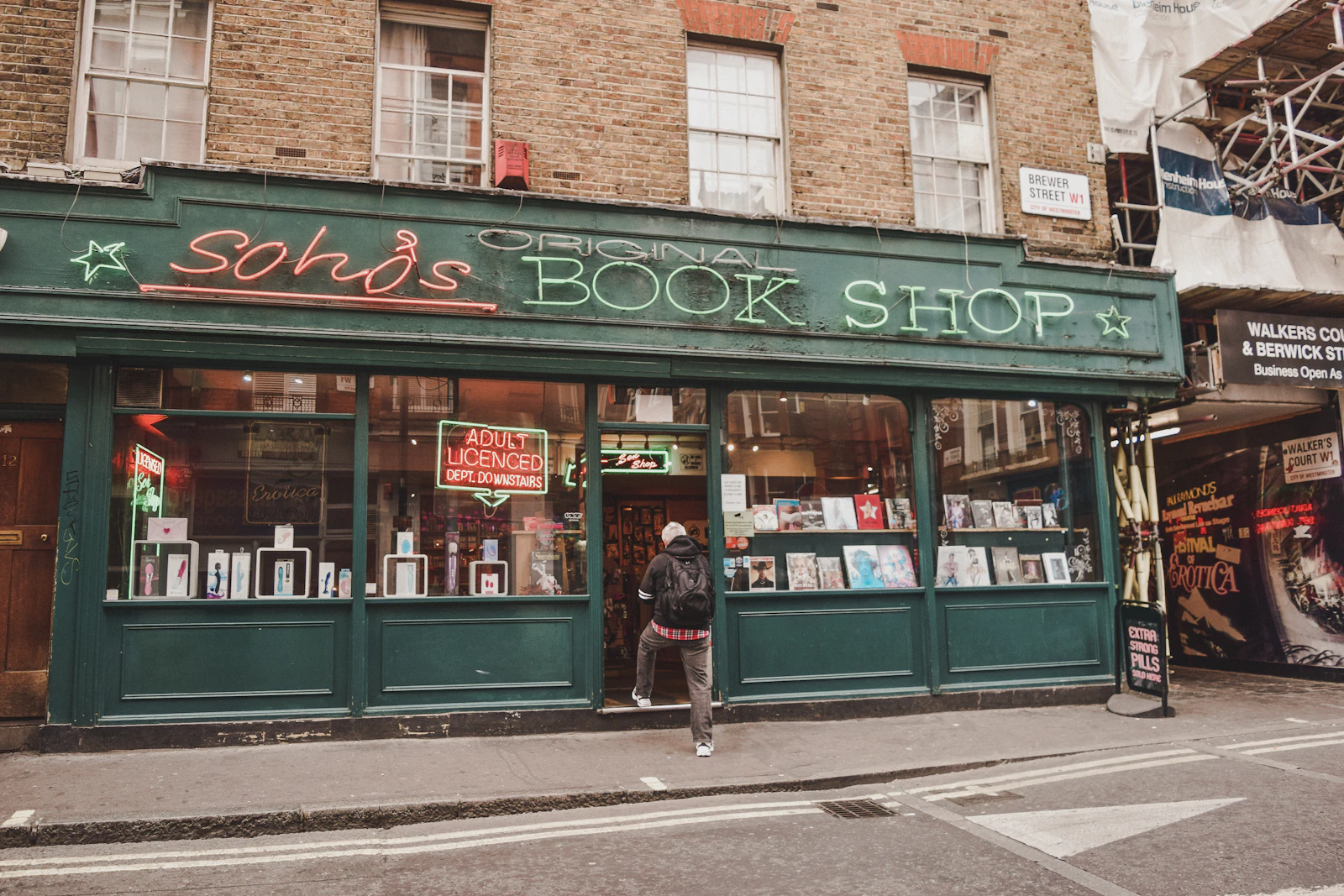 Traditional green-painted bookshop front on a bright day