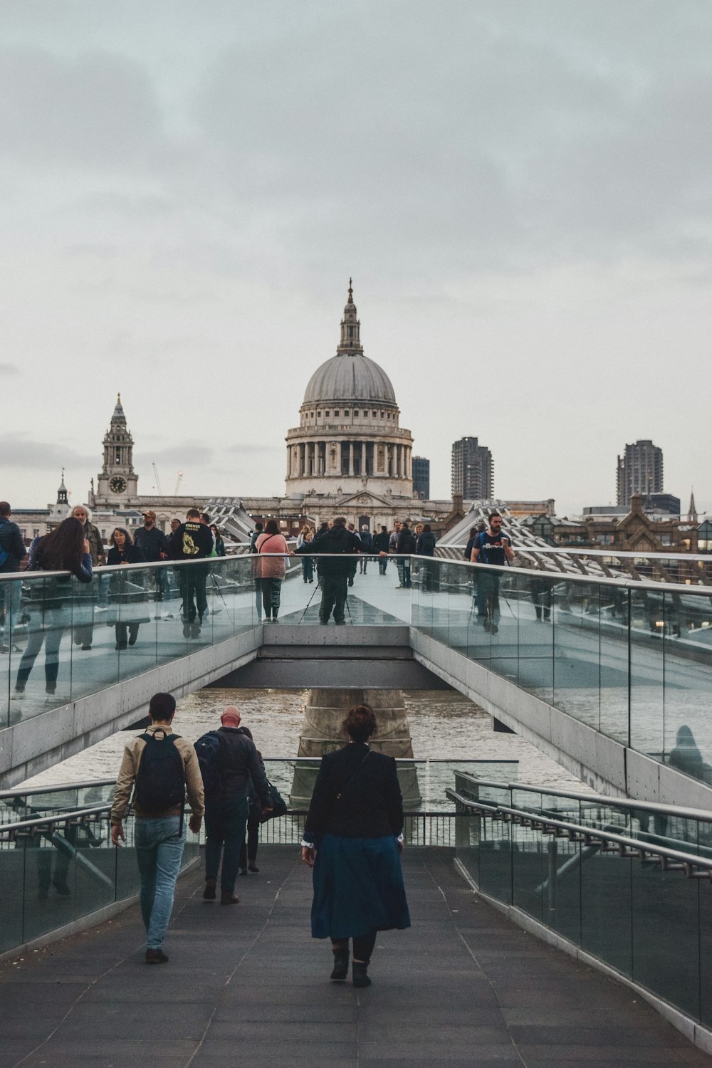 people walking on white concrete bridge during daytime