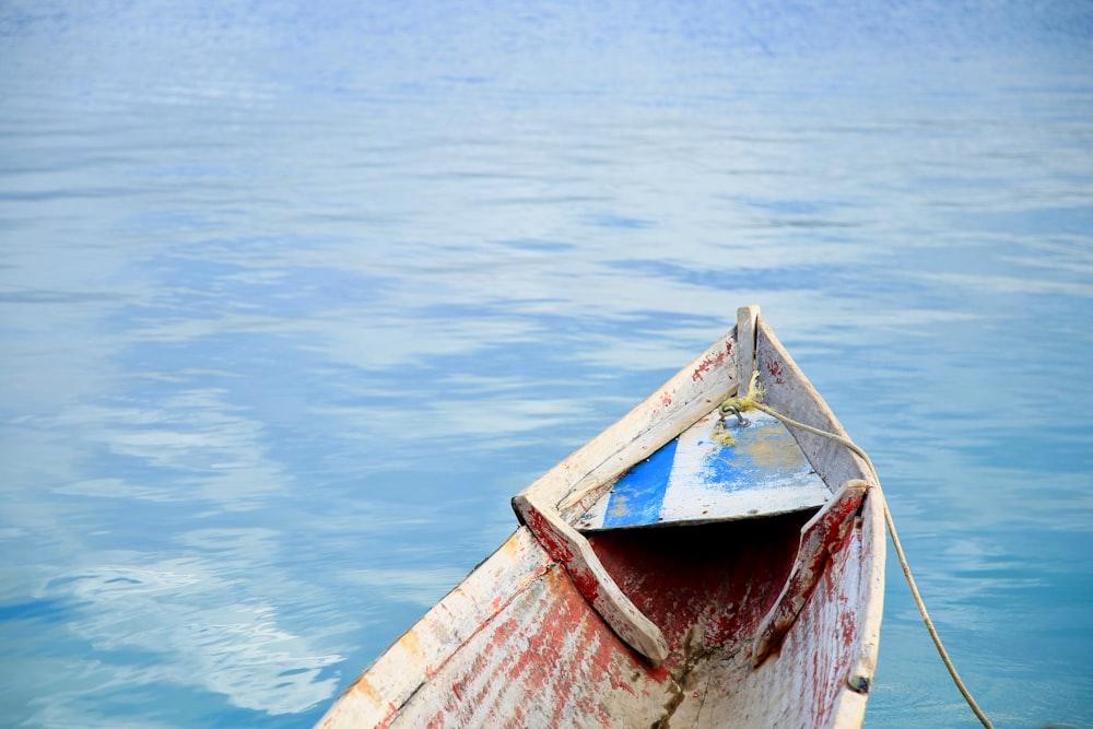 brown wooden boat on body of water during daytime