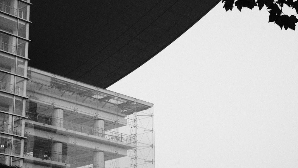 grayscale photo of building under cloudy sky