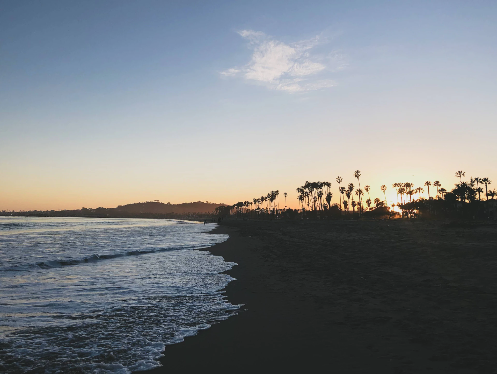 woman wearing yellow long-sleeved dress under white clouds and blue sky during daytime