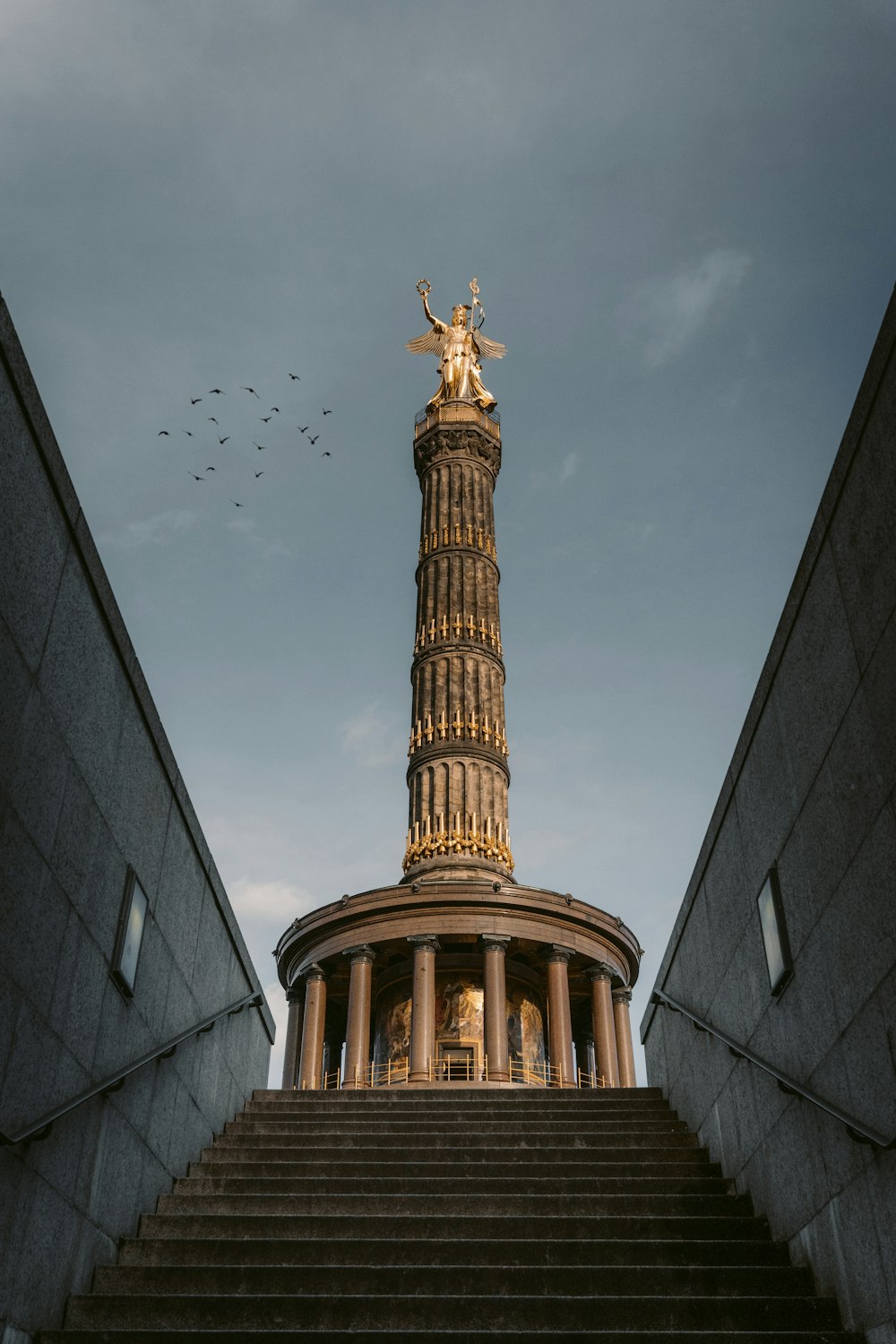 brown concrete tower under white clouds during daytime