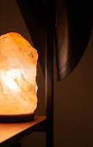 Close-up of glowing Himalayan salt crystals casting warm light in a peaceful room.