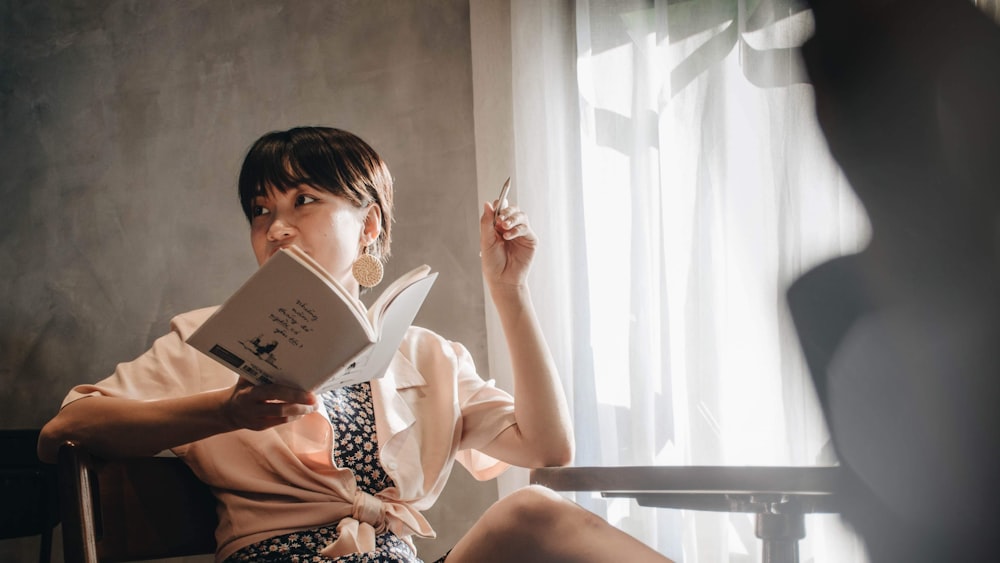 woman in white shirt reading book