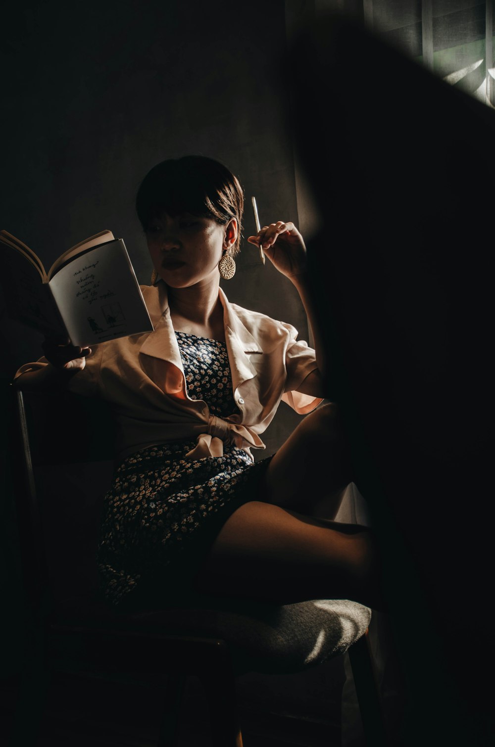 woman in white and black dress reading book