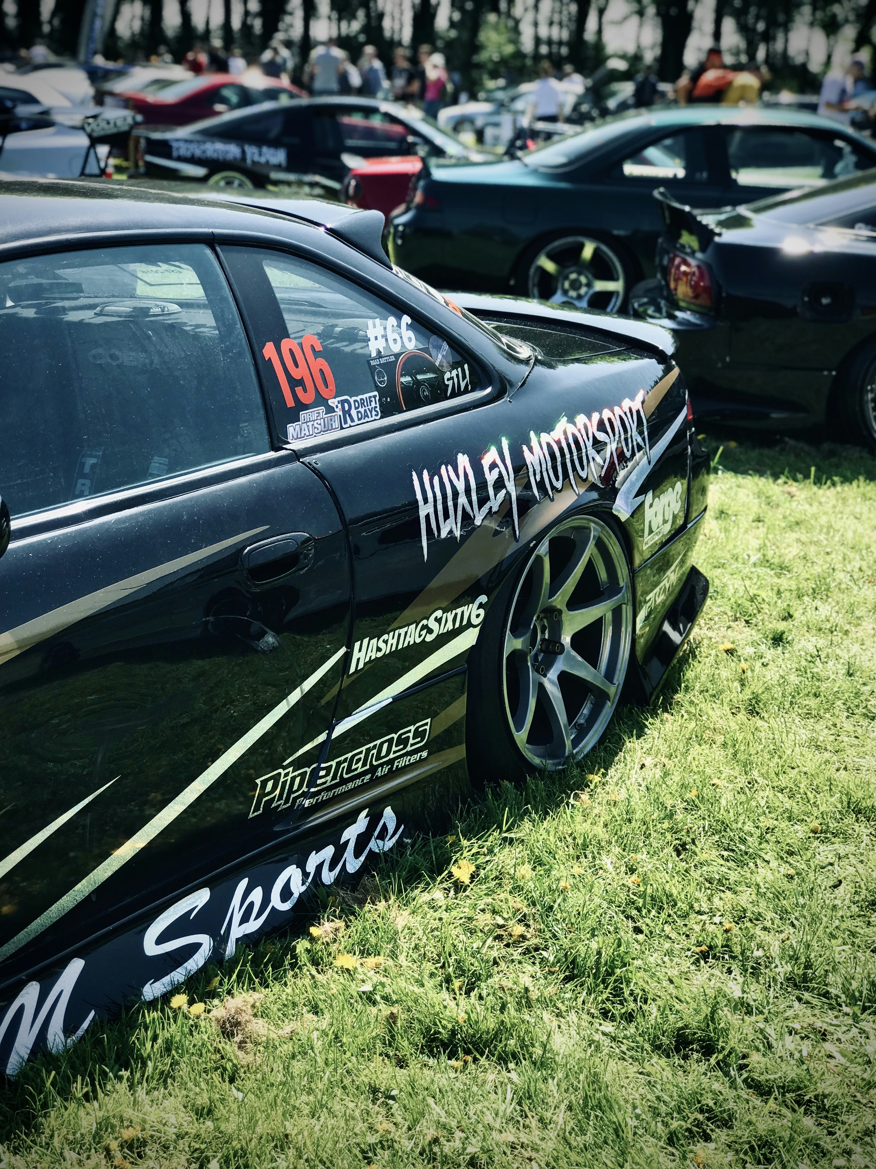 black porsche 911 on green grass field during daytime