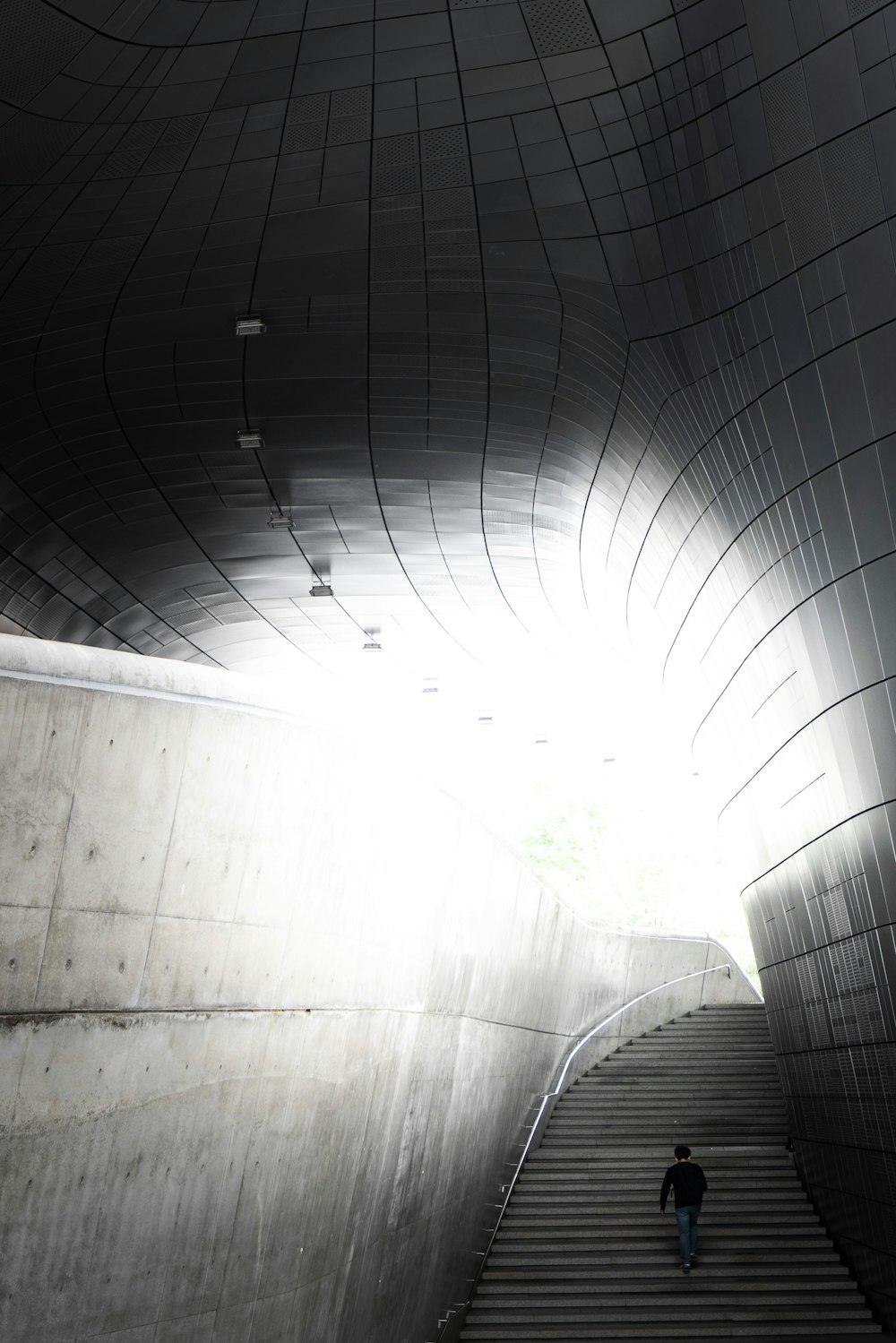 white concrete tunnel with green plants