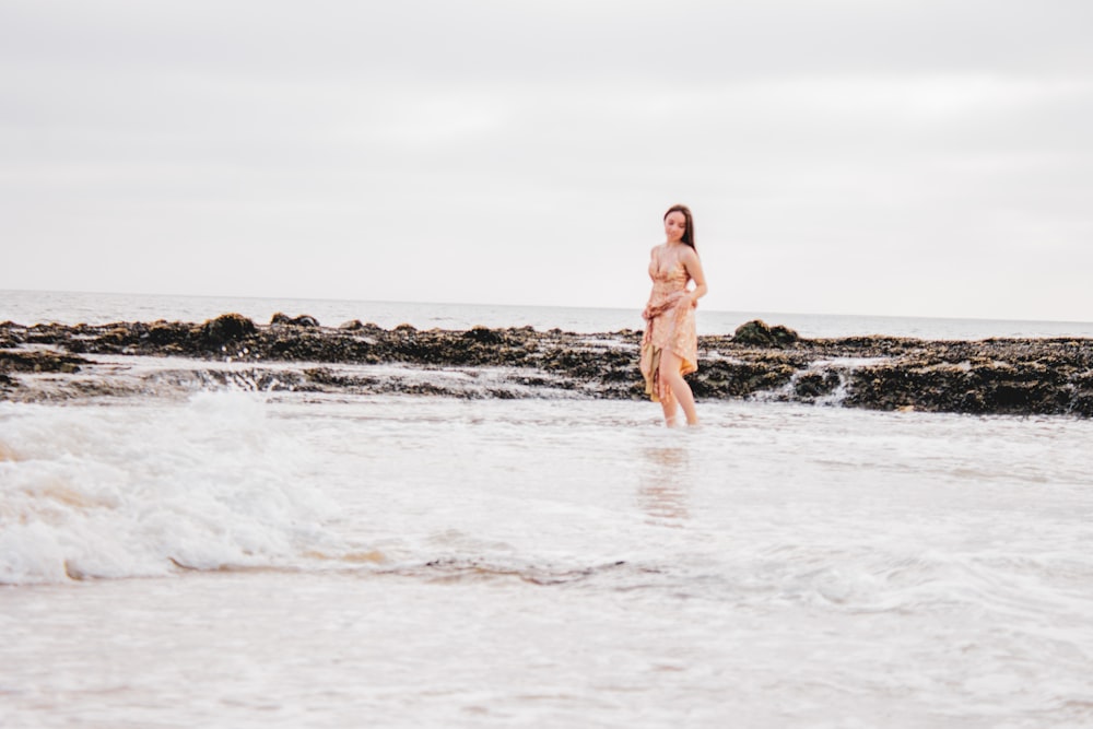 woman in brown bikini standing on beach during daytime