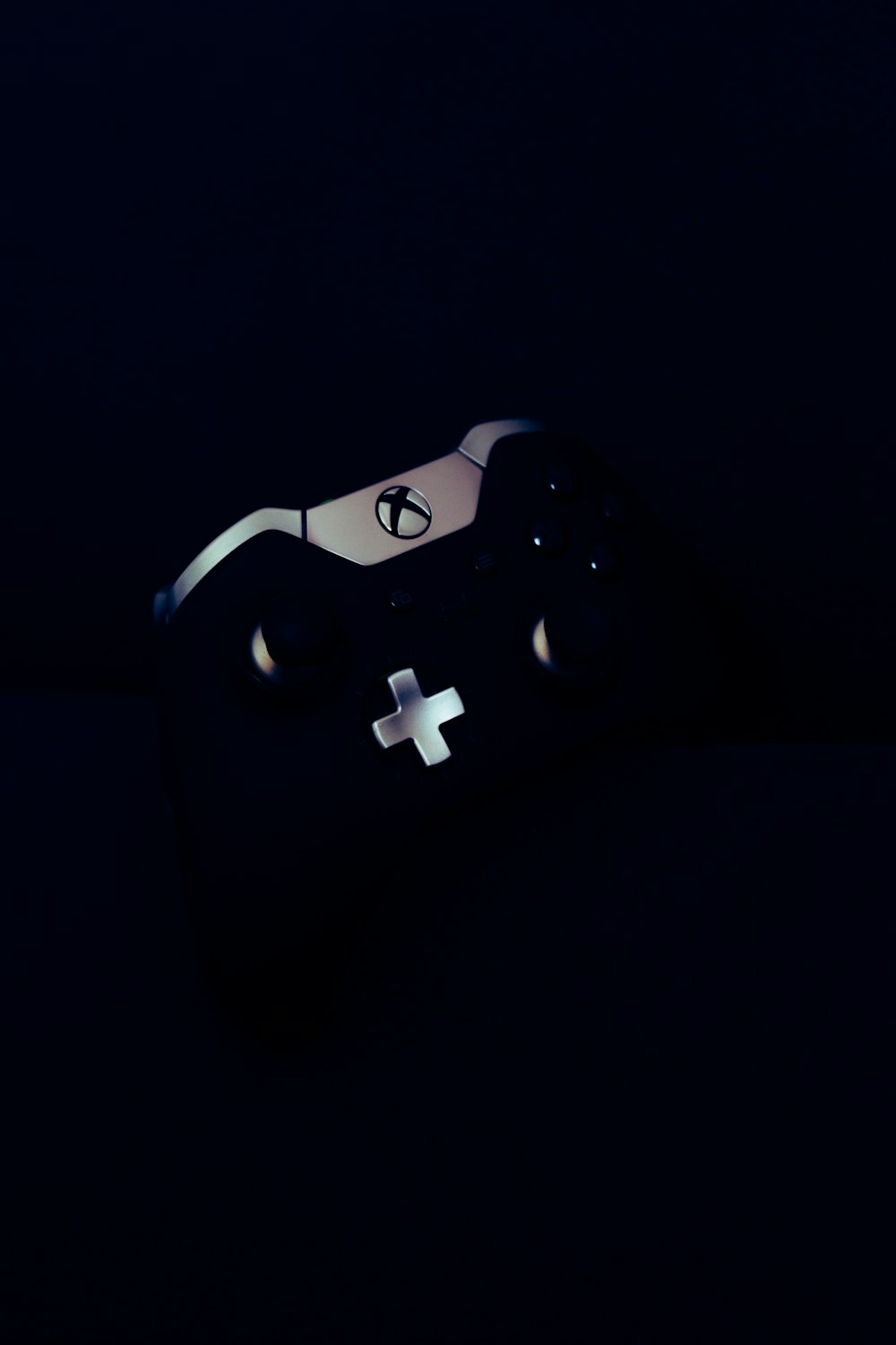 a close up of a controller in the dark