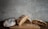 Close-up of freshly baked sourdough bread cooling on a wooden board with a rustic kitchen background