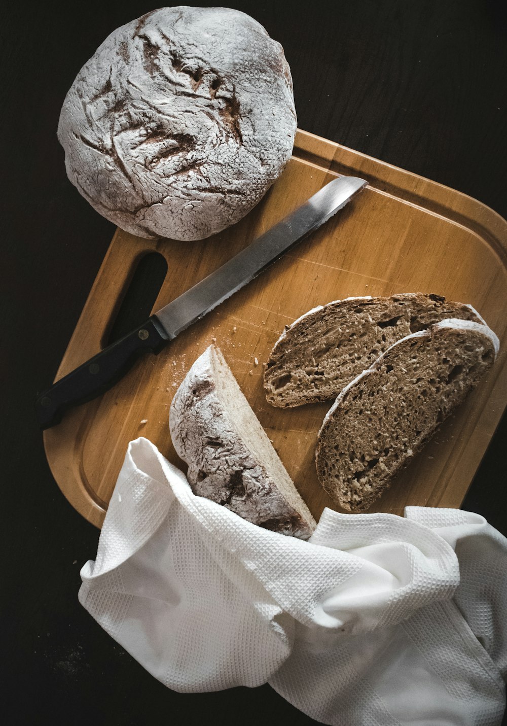 bread on brown wooden round plate