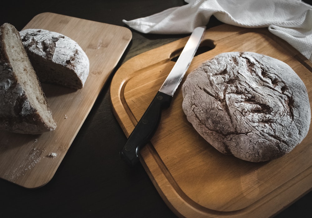 brown bread knife on brown wooden chopping board