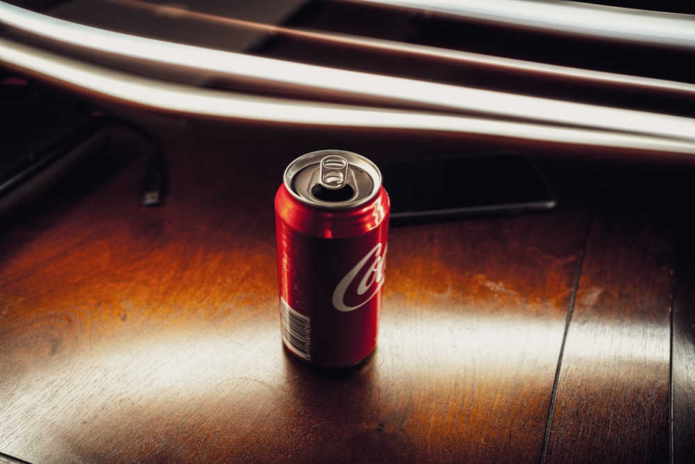 coca cola can on brown wooden table