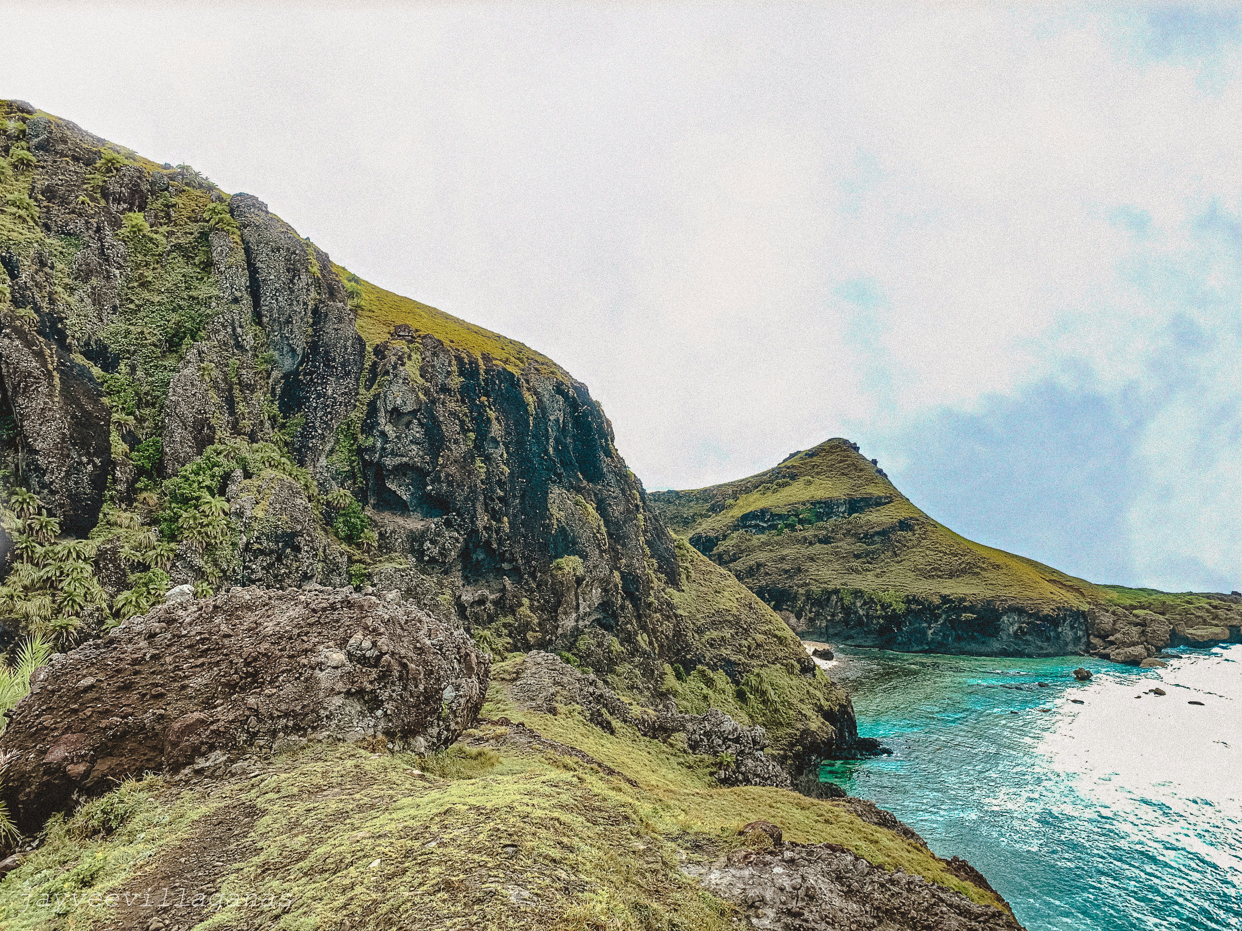 green and brown mountain beside body of water during daytime, Batanes Mountains 