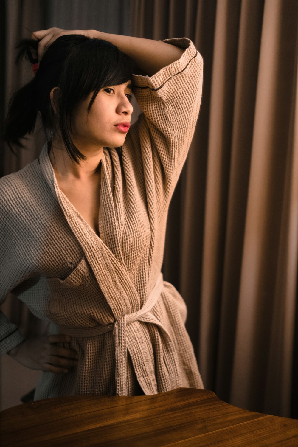 woman in brown scarf and gray coat