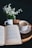 white and blue ceramic mug on brown wooden table