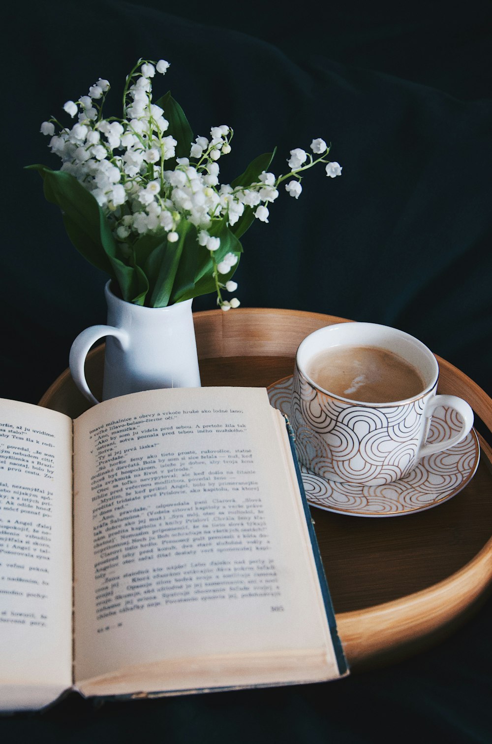 white and blue ceramic mug on brown wooden table