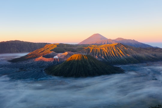 brown mountain under white clouds during daytime in Mount Bromo Indonesia