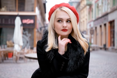 woman in black jacket and red knit cap girl google meet background