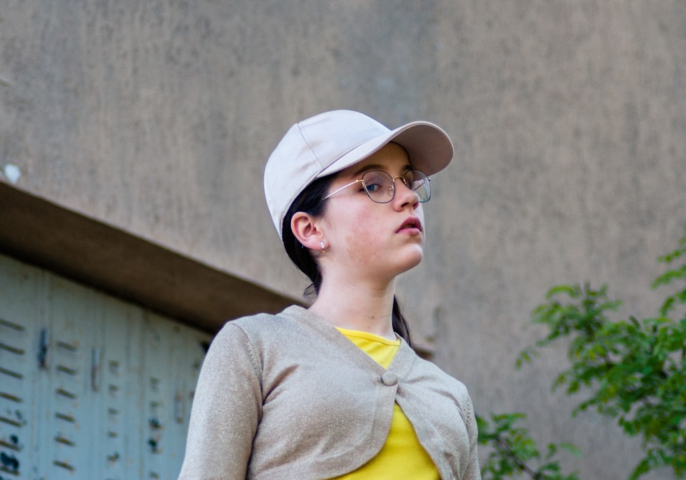 woman in yellow button up shirt and white hat