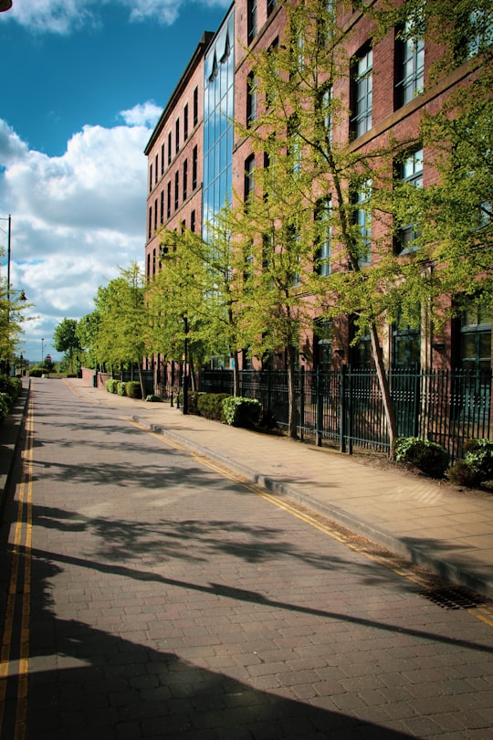 brown concrete building near green trees during daytime in Leeds United Kingdom