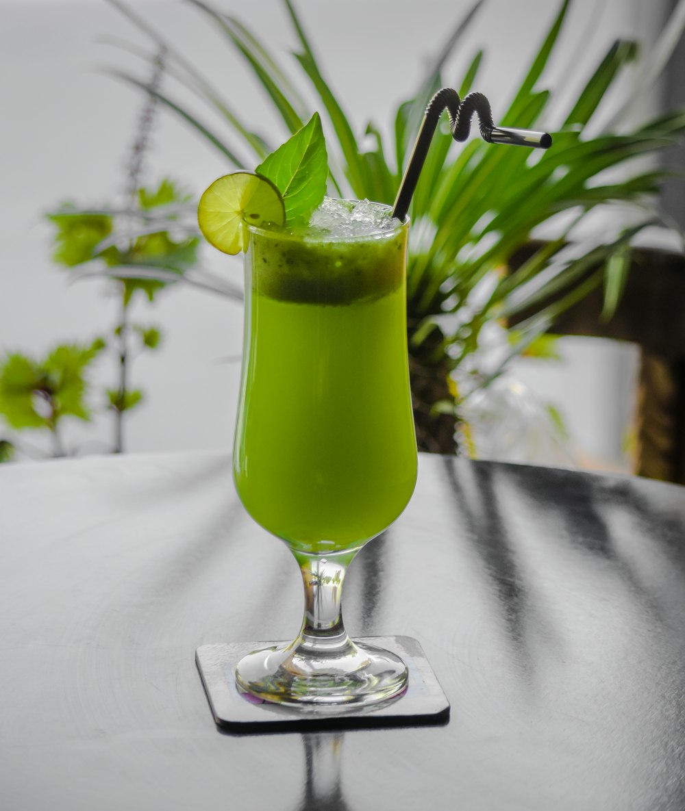 green liquid in clear wine glass