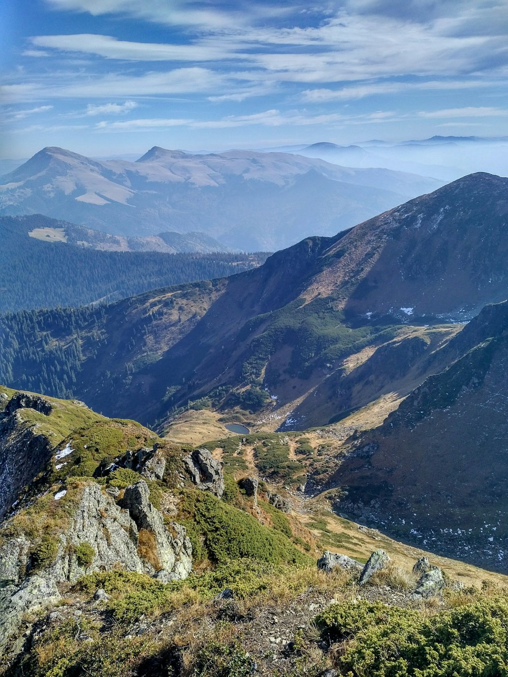 green and brown mountains under white clouds during daytime