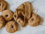 brown knit cap on white textile