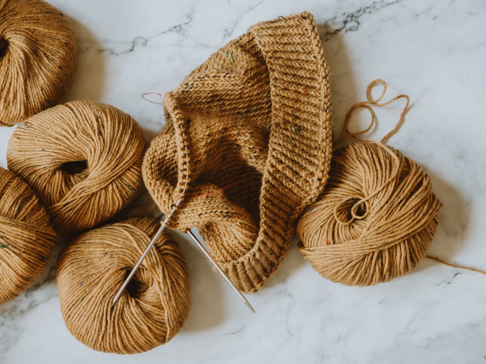 brown knit cap on white textile