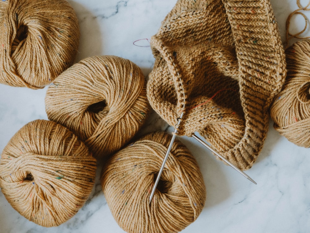 brown yarn on white textile