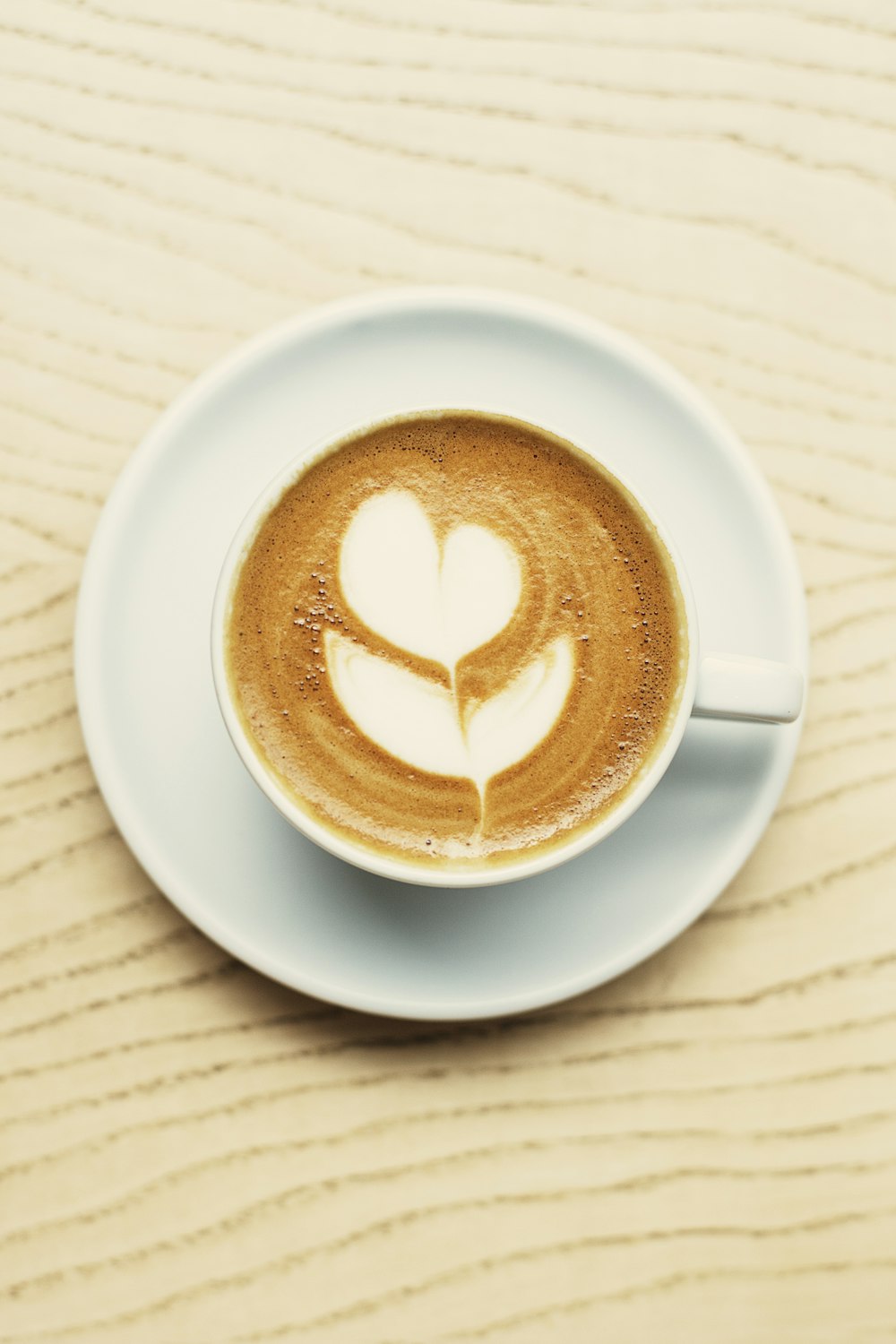 white ceramic mug with heart shaped coffee