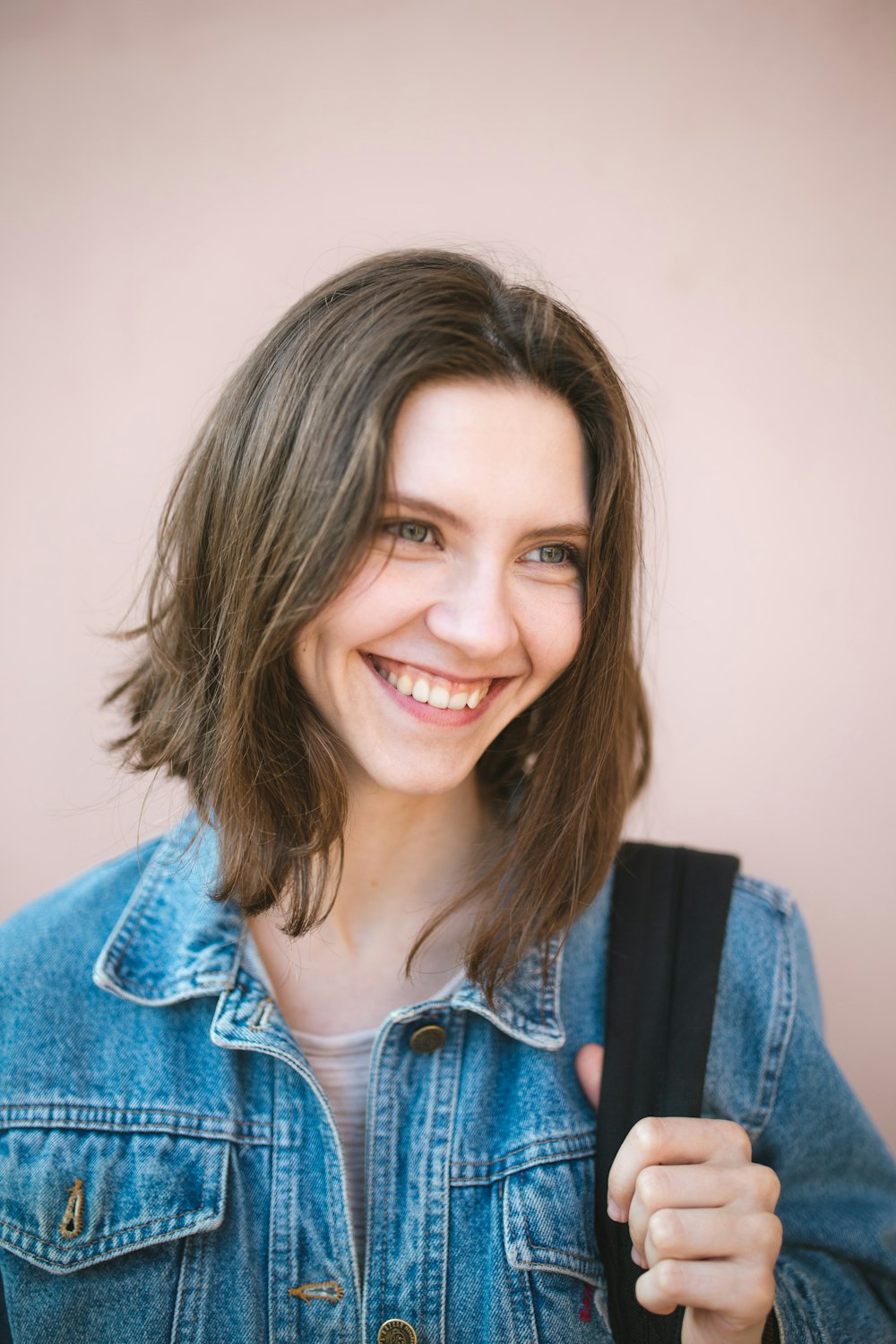 woman in blue denim jacket smiling