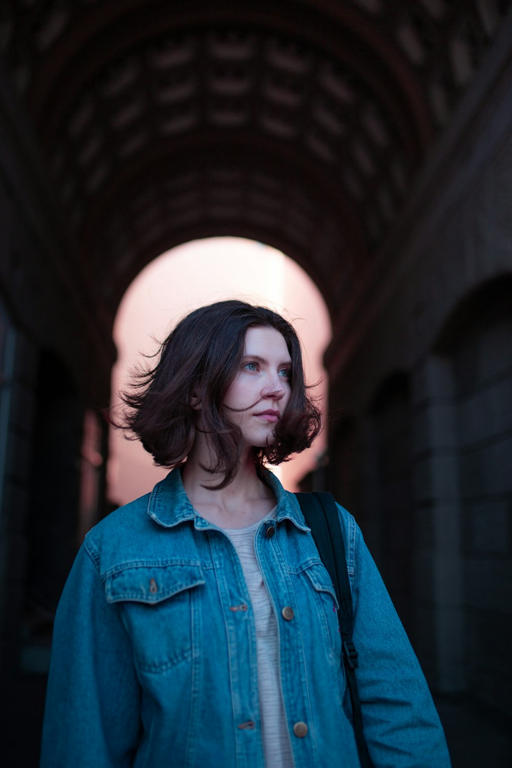 woman in blue denim jacket wearing black framed eyeglasses