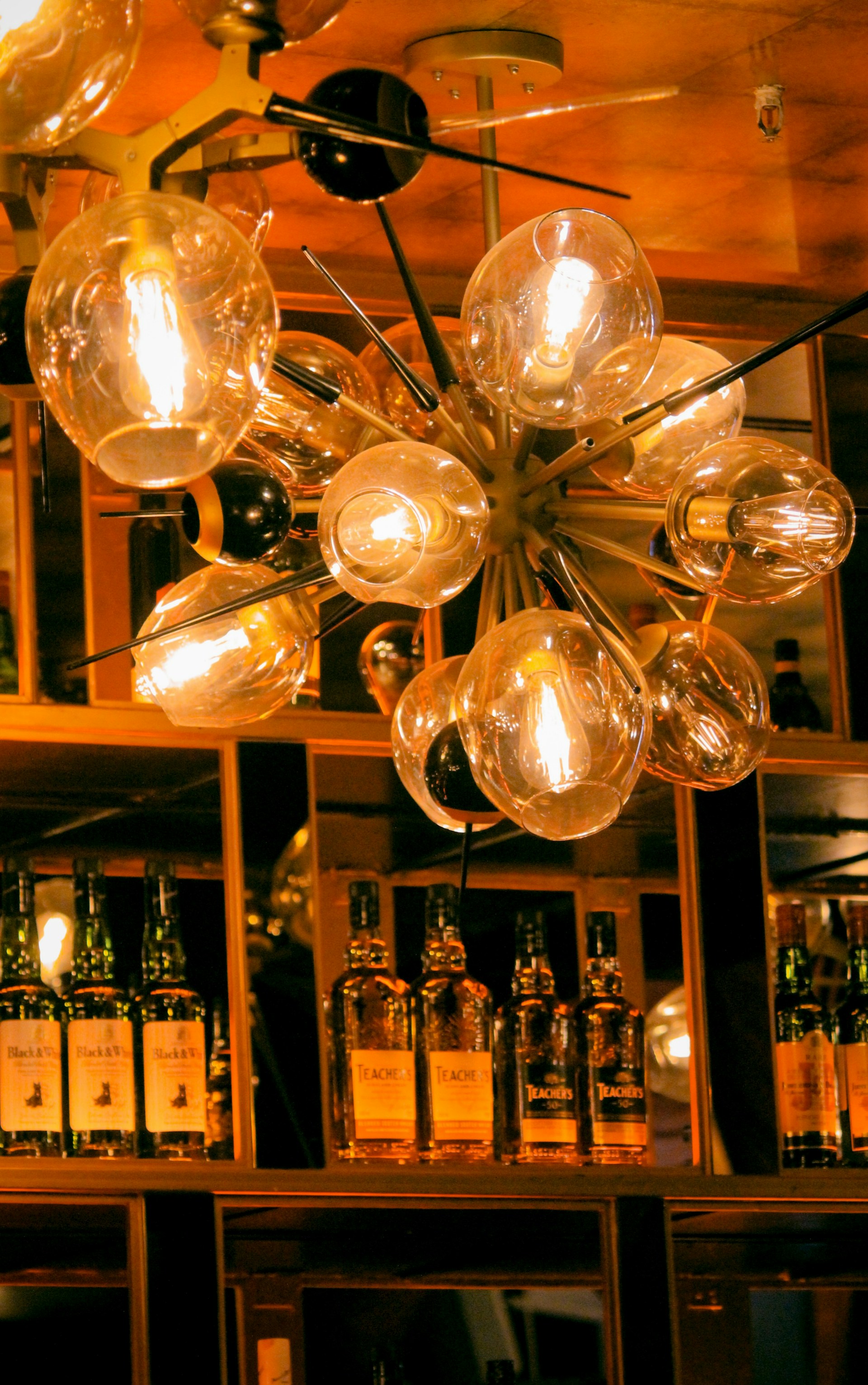 clear glass pendant lamps turned on during daytime