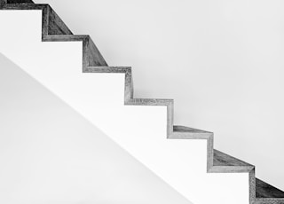 white concrete stairs with black metal railings