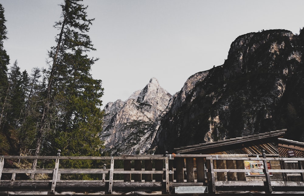 brown wooden fence near brown rocky mountain during daytime