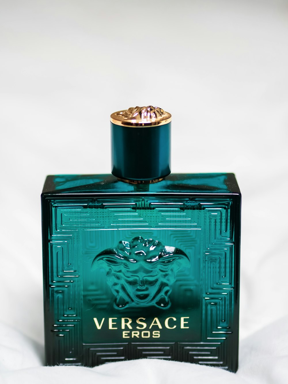 green and gold perfume bottle