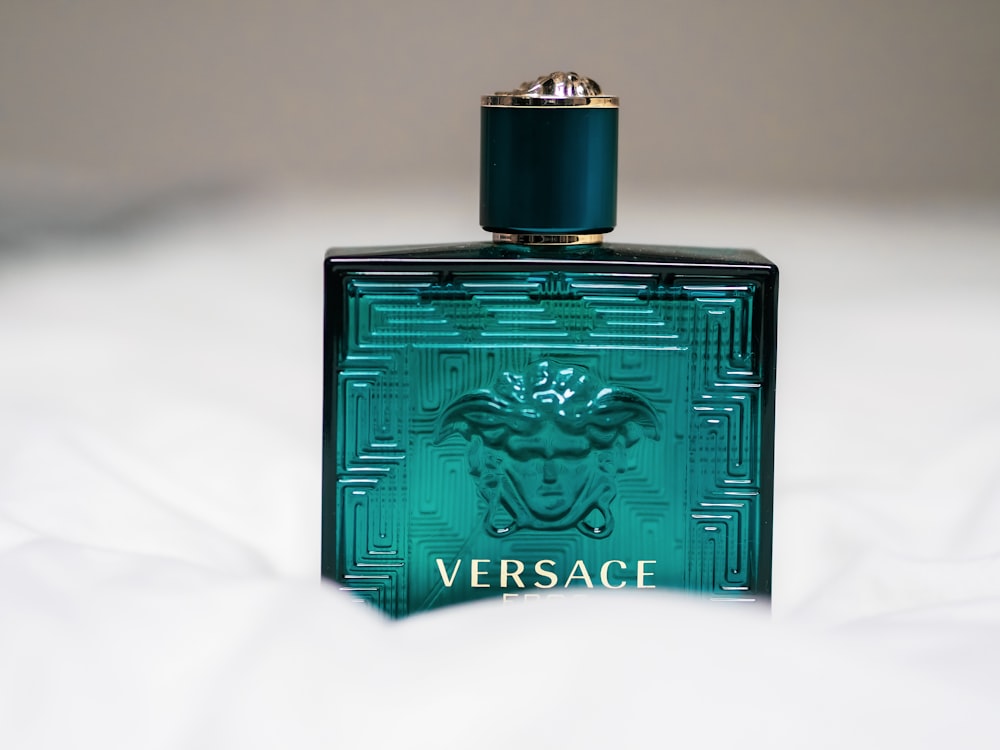 green and black perfume bottle