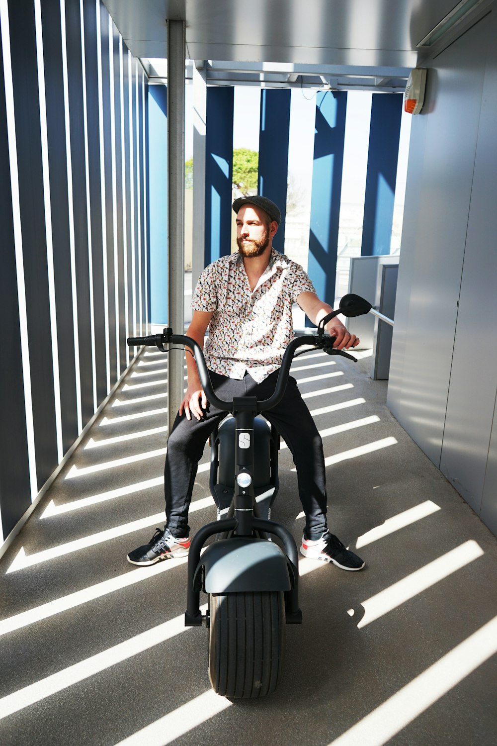 woman in blue and white dress shirt riding on black and gray motor scooter