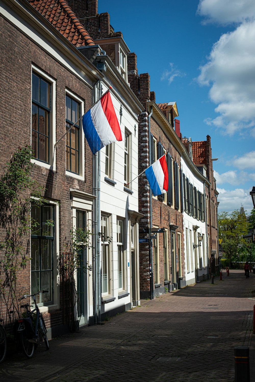 brown and white concrete building with flags on the side