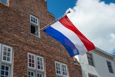 brown brick building with flag of america