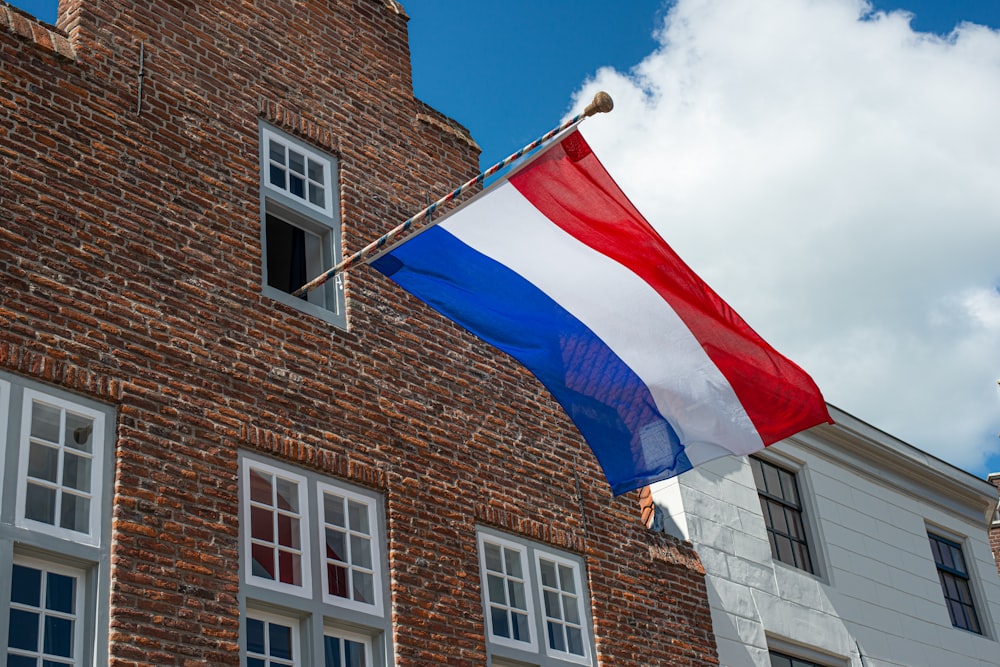 brown brick building with flag of america