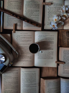 A vintage radio surrounded by books and a steaming cup of coffee.