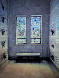 A peaceful crematorium interior with soft blue and lilac lighting, evoking calm and respect.