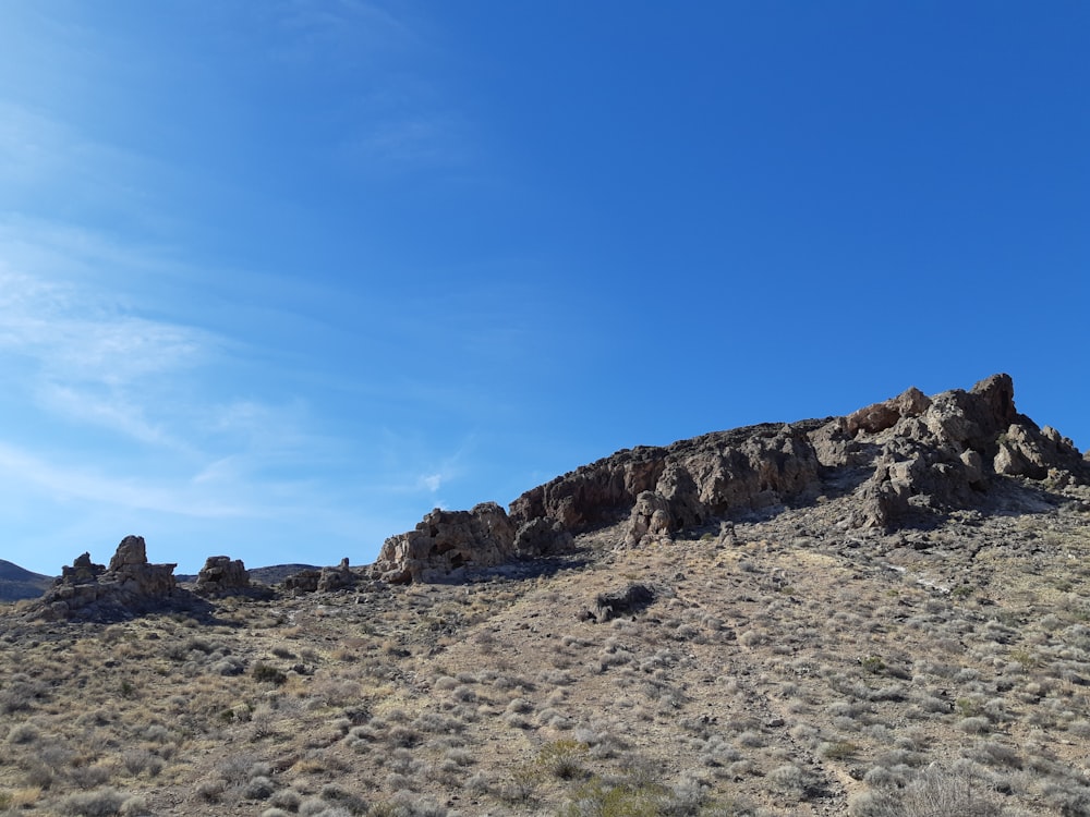 brown rocky mountain under blue sky during daytime