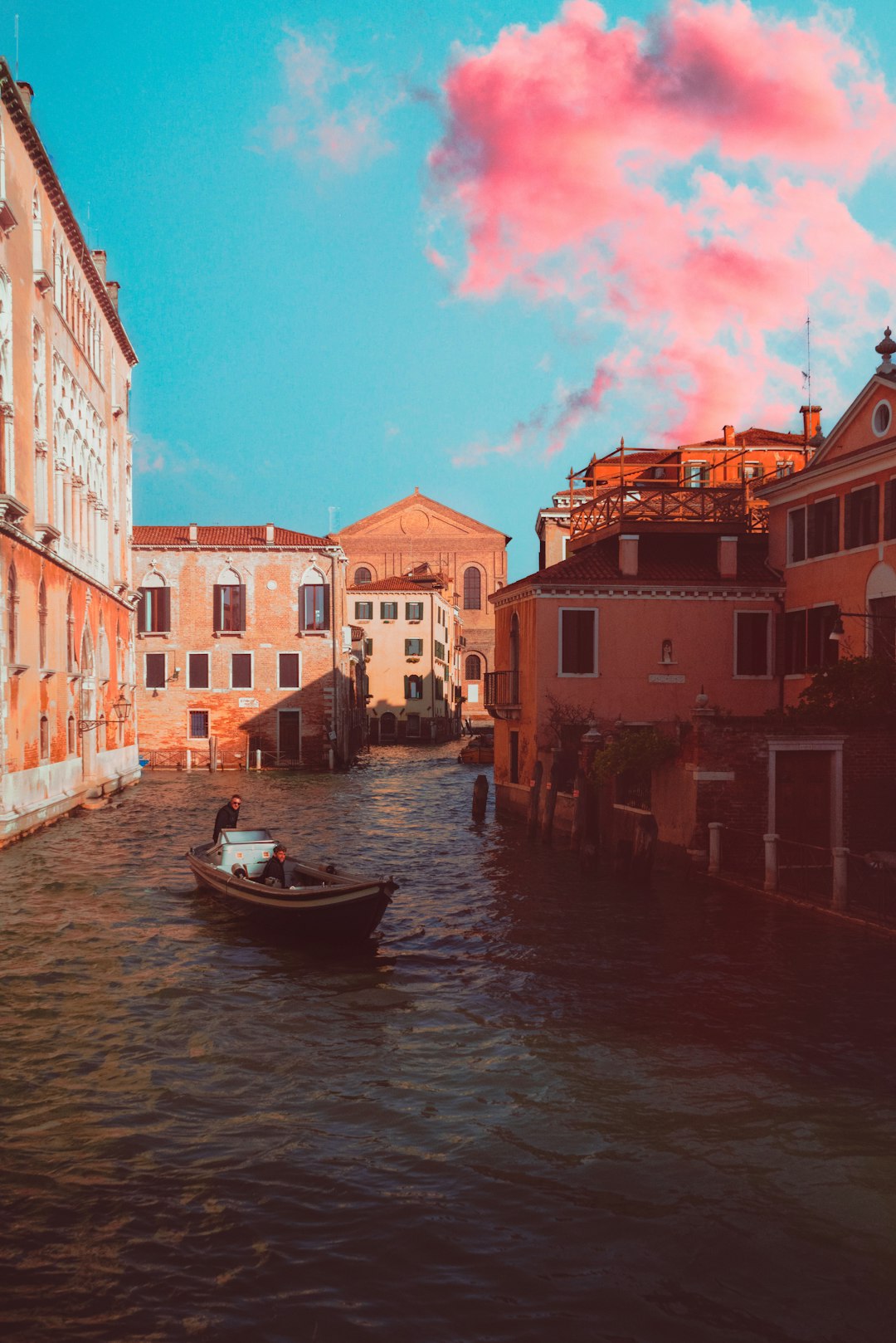 boat on river between buildings during daytime