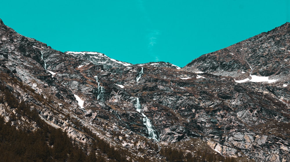 snow covered mountain under blue sky during daytime